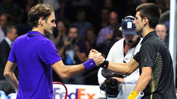 Roger Federer shakes hands with Novak Djokovic after the final.