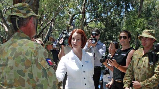Prime Minister Julia Gillard speaks to Australian Army personnel in Nyah, near Swan Hill, as they assist sandbagging efforts.