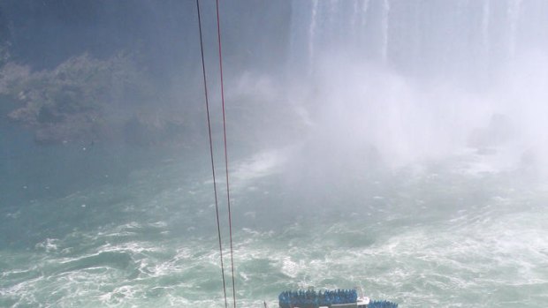 Emergency officials rescue a man who plunged over Niagara Falls.