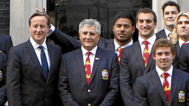 Manu Tuilagi puts two fingers behind the head of British Prime Minister David Cameron.