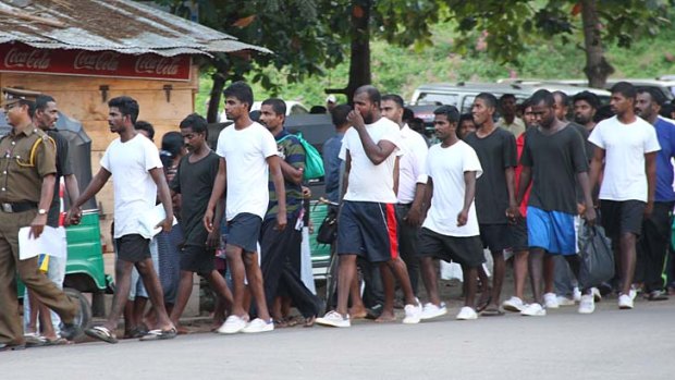 Deported ... a group of Sri Lankans sent back to their country is led from prison to the court in Negombo.