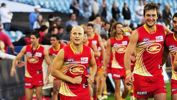 What a win: Gold Coast players celebrate on Saturday.