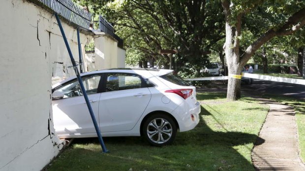 The car lodged in the wall of the Lodge in Canberra after a collision on Saturday morning.