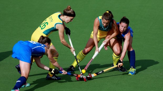 Australians Emily Smith and Jayde Taylor are tackled by Scots Leigh Fawcett and Linda Clement.