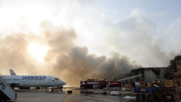 Airport raid: Pakistani firefighters extinguish fires after militants attack Jinnah International Airport in Karachi.