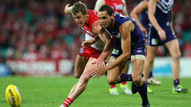 On the chase: The Swans' Luke Parker and the Dockers' Michael Johnson vie for the ball.