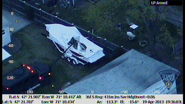 Police helicopter photo of a police vehicle using a boom to look insde the boat where Dzhokhar Tsarnaev was hiding.