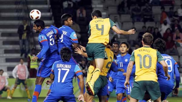 Tim Cahill soars above the Indian defenders to head home his second goal and the team's fourth.