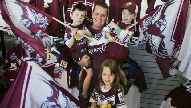 Showing their true colours: Manly supporter Geoff Ferris with twins Matthew, left, and Benjamin, and daughter Emma.