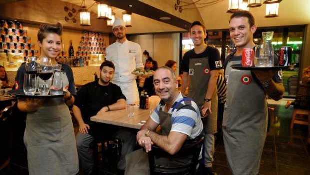 Woodstock Pizzicheria owner Tony Cannata with 457 visa workers at his restaurant.