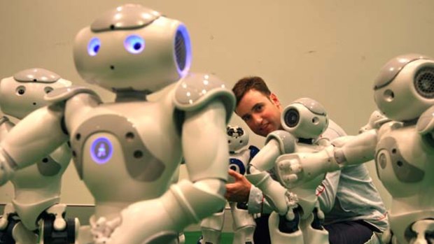 Hip-hop array ... Benjamin Johnston with humanoid Nao robots at the University of Technology, Sydney's social robotic studio.