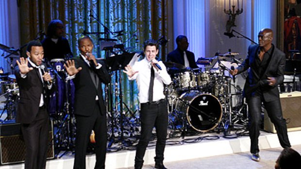 In a White House tribute to Motown, singers (from left) John Legend, Jamie Foxx, Nick Jonas and Seal perform before the Obamas this week, with George Washington's portrait behind.