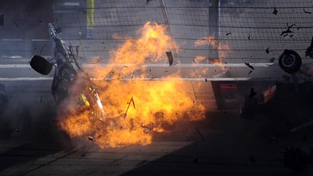 Dan Wheldon's car bursts into flames after being hit in a 15-car pile-up in the Las Vegas IndyCar race.