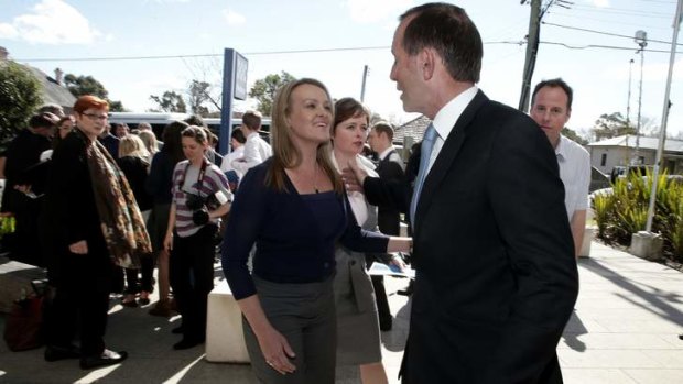 Tony Abbott and Liberal candidate Fiona Scott visit the St Marys police station in western Sydney on Monday.