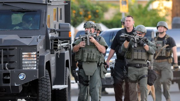 Authorities search for a gunman believed to be on the run after the San Bernardino shooting. 