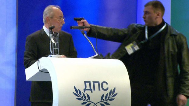 Close call ... politician Ahmed Dogan looks at the  man who threaten him with a pistol during his speech at his party's national party conference in Sofia.