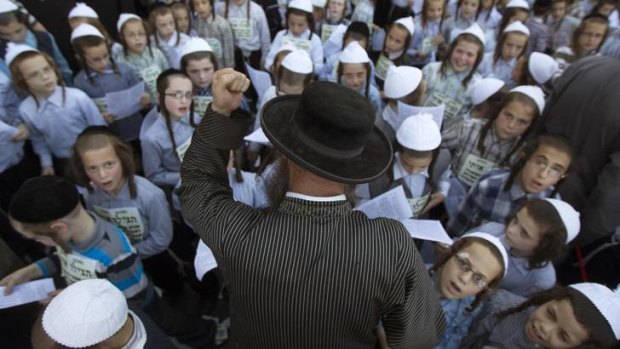 Boys are encouraged to pray during a Jerusalem protest against conscription legislation that might force ultra-Orthodox Jews to serve in the military.