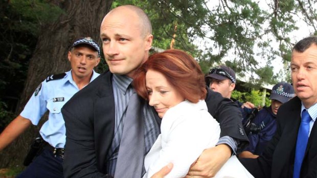 Prime Minister Julia Gillard is dragged to safety amid protests on Australia Day. The Opposition has called for inquiry into the leak that caused the security scare.