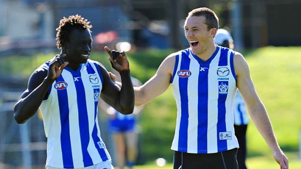 Drew Petrie (right)  has a laugh at training with Majak Daw.
