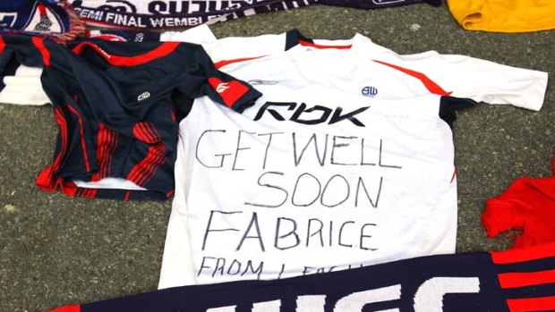 Hopeful ... Tributes and get well messages are laid outside the Reebok Stadium for Bolton Wanderers' Fabrice Muamba.