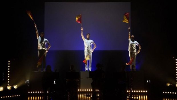 Bright red and yellow semaphore flags deliver colour and dazzling movement in Kate Neal's production.