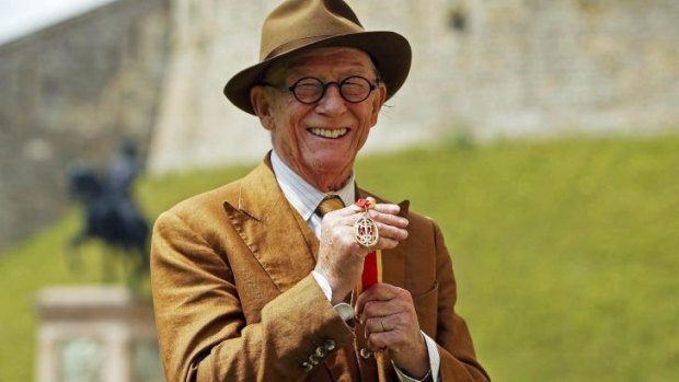 British actor John Hurt holds his award of a Knighthood presented by Britain's Queen Elizabeth II during an Investiture ceremony at Windsor Castle, England.