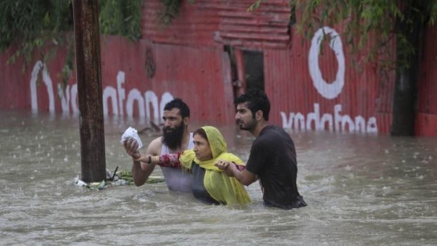 Kashmiri men help a woman move to a safer place after her neighbourhood was flooded in Srinagar, India. At least 100 villages across the Kashmir valley were flooded by overflowing lakes and rivers, in the worst flooding in 22 years caused by heavy rains.