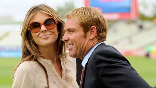 Shane Warne with his current preoccupation, Liz Hurley.