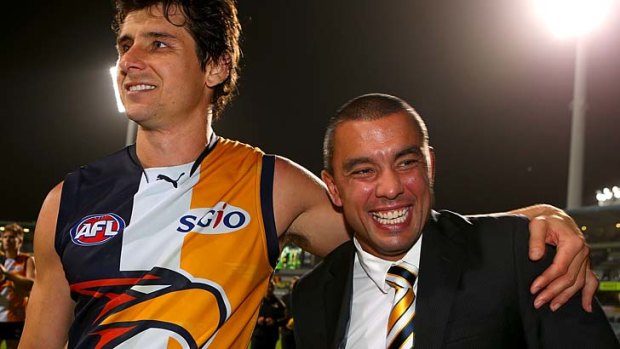 Andrew Embley of the Eagles embraces Daniel Kerr after playing his last game for the club in round 23 2013.