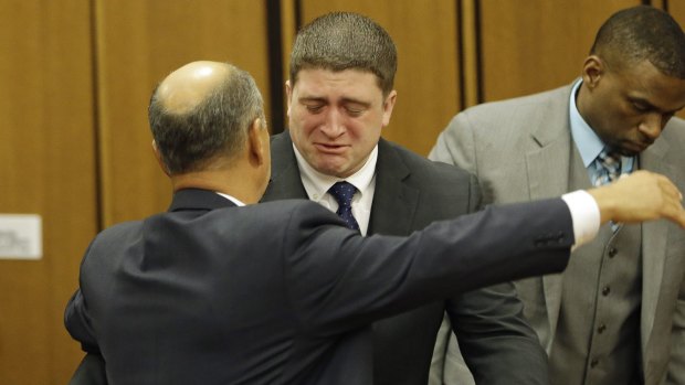 Cleveland police officer Michael Brelo hugs his attorney, Patrick D'Angelo after being found not guilty.