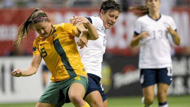 Laura Alleway tangles with Abby Wambach.
