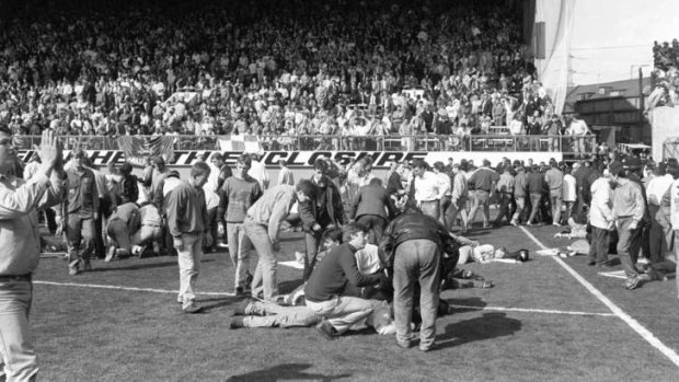 Tragedy &#8230; fans on the pitch receiving attention after severe crushing at Hillsborough stadium in Sheffield.