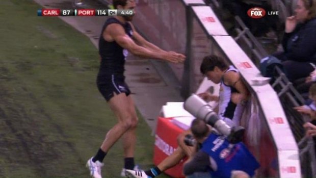 Round one: Andrew Walker throws Angus Monfries into the fence.