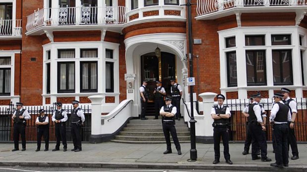 British police officers stand guard outside the Ecuadorian Embassy in central London after after Ecuador announced it had granted political asylum to WikiLeaks founder Julian Assange.
