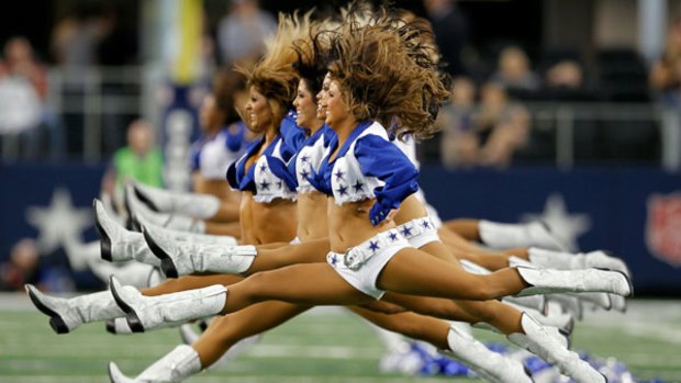 Hair-raising routine: The Dallas Cowboys cheerleaders perform before a match.