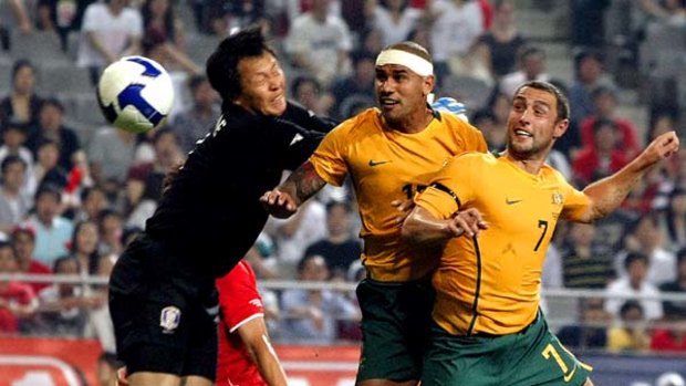 Australia's  Patrick Kisnorbo, center, scores against South Korea in Seoul, Sept. 5, 2009.