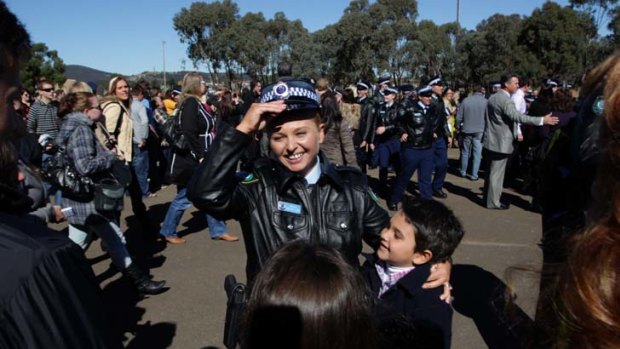 If the cap fits ... a delighted Linda-Arzu Gunes hugs her son Baran after the graduation parade at the NSW Police Academy in Goulburn yesterday.
