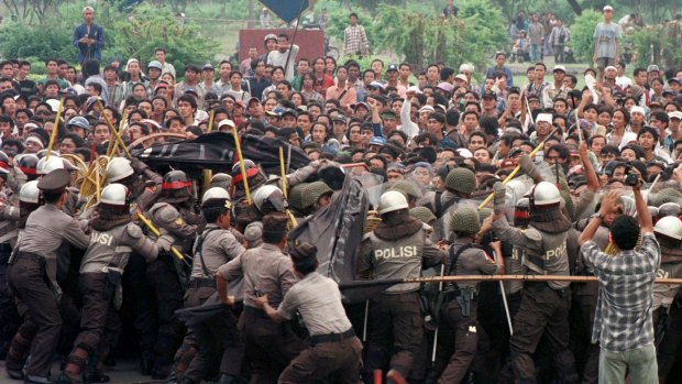 Indonesian anti-riot police try to push a group of students during a protest against rising prices and unemployment.