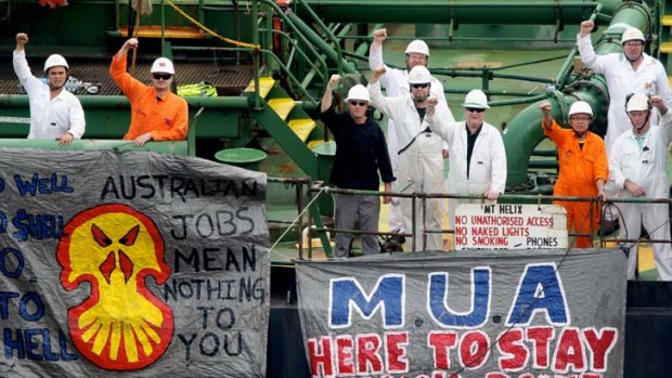 Defiant ... crew members of the Araluen Spirit at Shell's Gore Cove terminal yesterday. Shell promised talks with the crew and the Maritime Union of Australia.