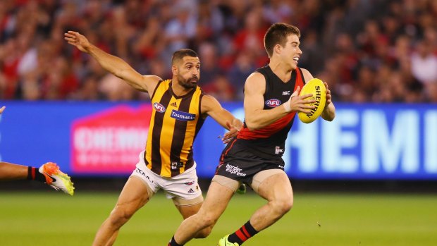 Bomber Zach Merrett outpaces Hawthorn's Paul Puopolo.