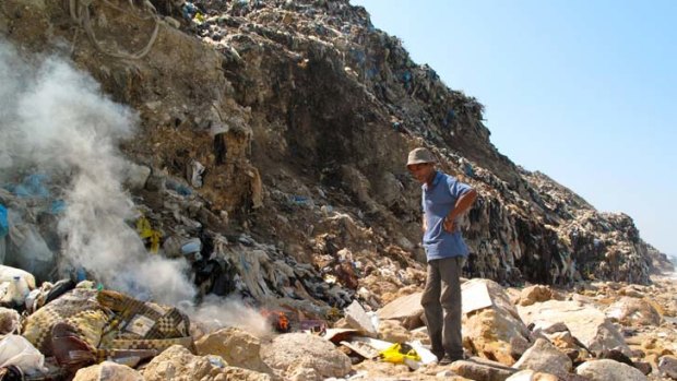 ''If only people stopped'' &#8230; Walid with his fire amid the rubbish in the illegal tip near Sidon.