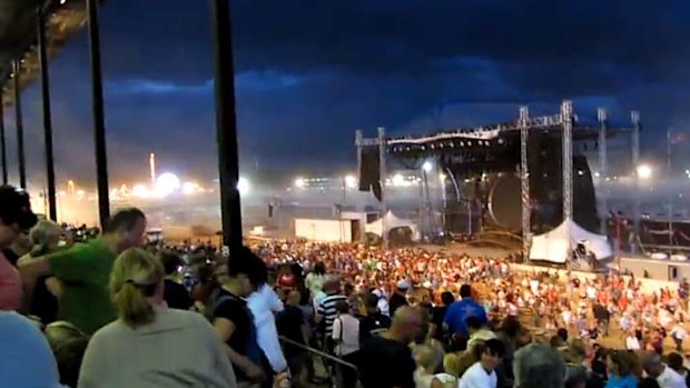 Five dead ... the stage is seen upright, moments before heavy winds blew it over.