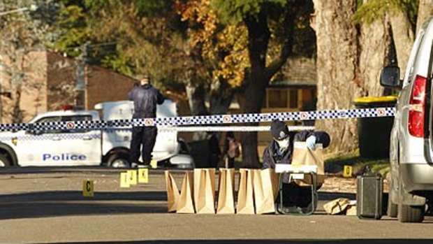 Police search for evidence where the victim was gunned down in Raymond Terrace.