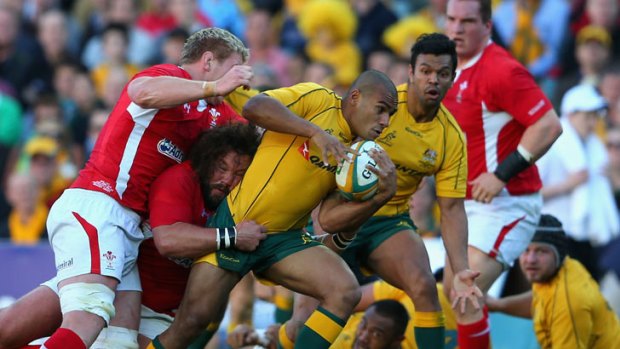 Will Genia of the Wallabies is tackled during the International Rugby Test match between the Australian Wallabies and Wales at Allianz Stadium on June 23, 2012 in Sydney, Australia.