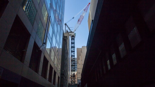 The massive "luffing" crane erected above St James Lane that will build the 57-storey tower on the tiny site. 