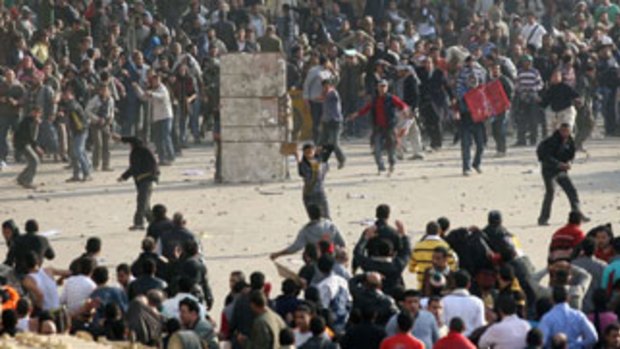 Widespread violence ... rocks and petrol bombs were thrown in clashes between supporters and opponents of the regime in Tahrir Square, killing four and wounding 829.