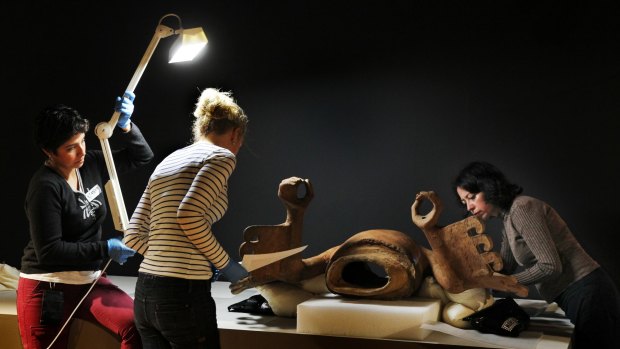 Australian Museum staff work on the Eagle Warrior sculpture on loan from Museo del Templo Mayor in Mexico.