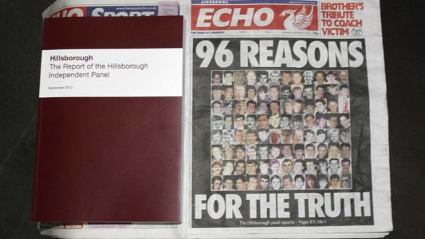 A copy of the report delivered by the Hillsborough Independent Panel is positioned next to a copy of the <i>Liverpool Echo</i> at a news conference announcing the panel's findings on the 1989 soccer disaster.