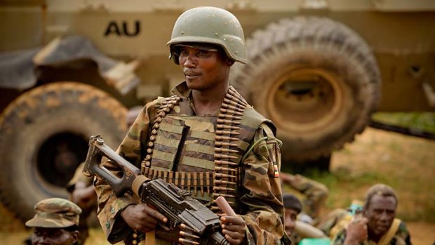 A Ugandan soldier, serving with the African Union Mission in Somalia prepares to board military trucks in Afgoye.
