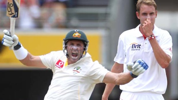 Michael Hussey, watched by England paceman Stuart Broad, celebrates reaching his century at the Gabba.